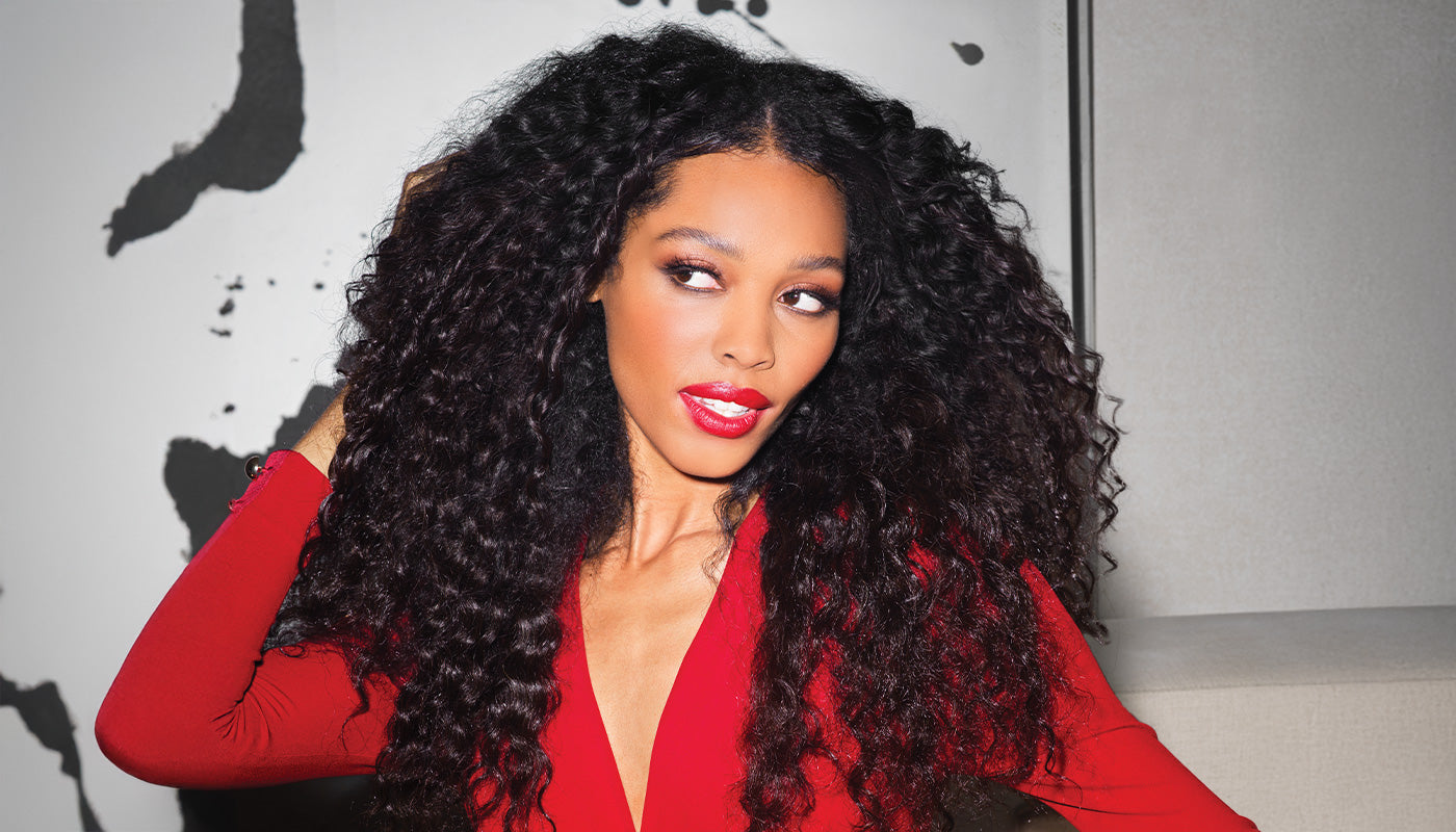 Female model with medium length curly dark hair