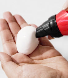 White mousse foam from Big Altitude dispensed in palm of hand