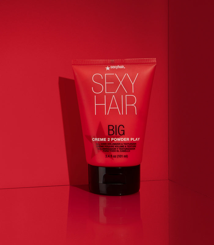 Big Creme 2 Powder Play tube on red background with textured cap