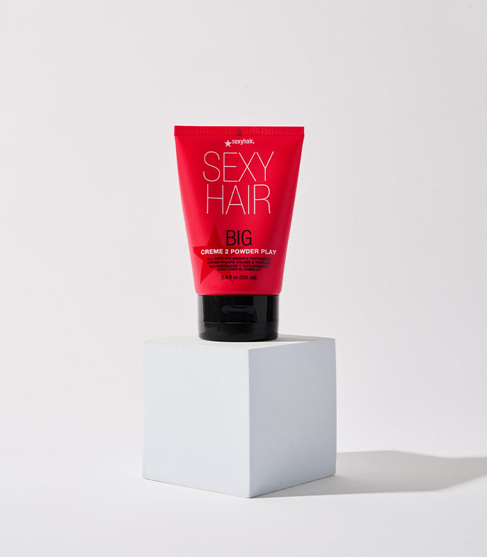 Big Creme 2 Powder Play tube displayed on white pedestal