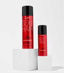 Big Dry Shampoo regular and travel sizes on white pedestals