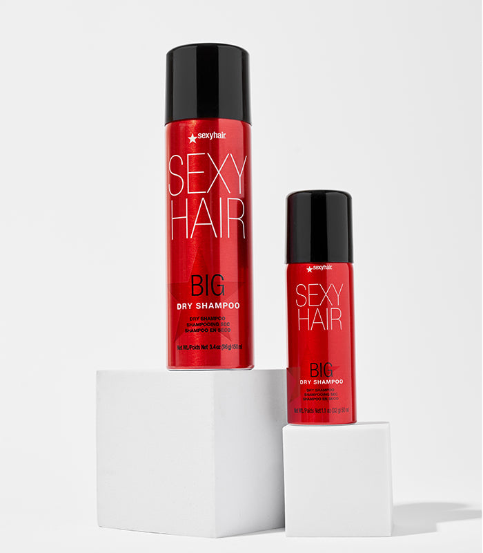 Big Dry Shampoo regular and travel sizes on white pedestals