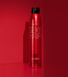 Big Get Layered hairspray bottle on red background