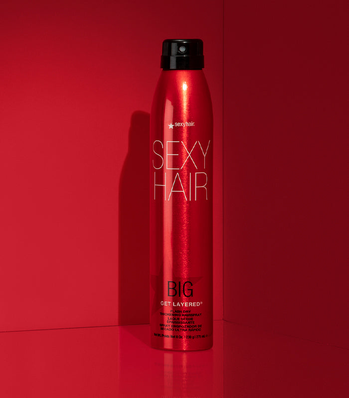 Big Get Layered hairspray bottle on red background
