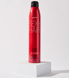 Big Get Layered hairspray displayed on white pedestal