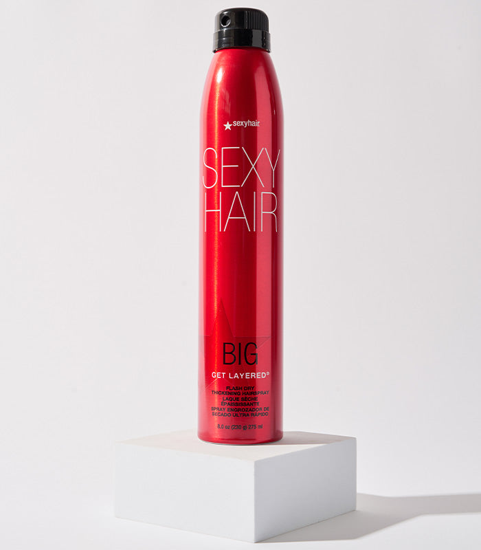 Big Get Layered hairspray displayed on white pedestal