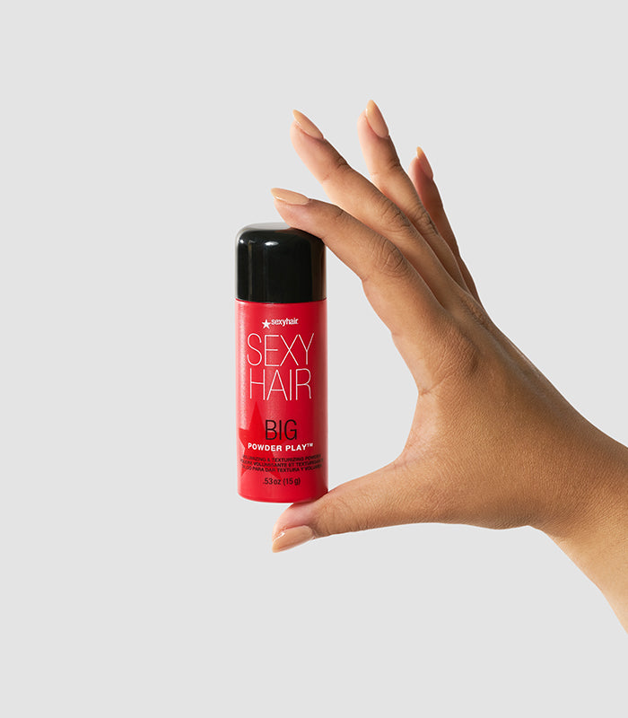 Big Powder Play container held in hand on white background