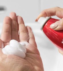 White mousse from Big Root Pump dispensed in palm of hand