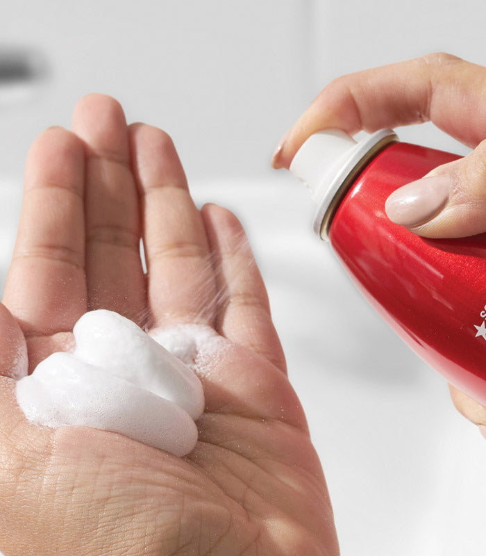 White mousse from Big Root Pump dispensed in palm of hand