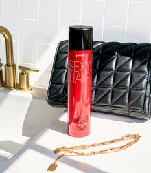 Big Spray & Play hairspray bottle displayed with styling items
