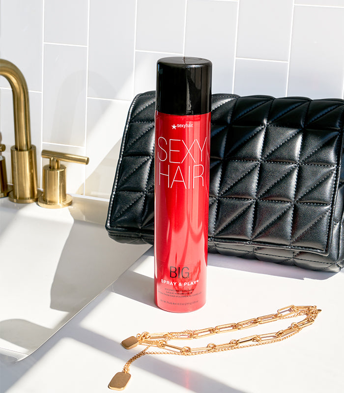 Big Spray & Play hairspray bottle displayed with styling items