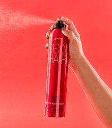 Hand spraying Big Spray & Play Harder with visible spray mist