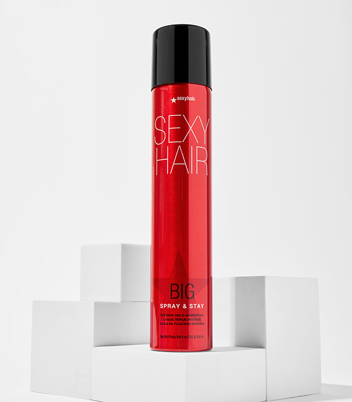 Big Spray & Stay bottle displayed on white pedestals