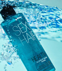 Healthy SexyHair Gloss N' Glow Rinse bottle immersed in water with blue liquid