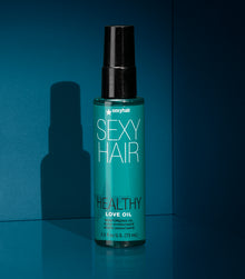 Healthy SexyHair Love Oil moisturizing spray on teal background