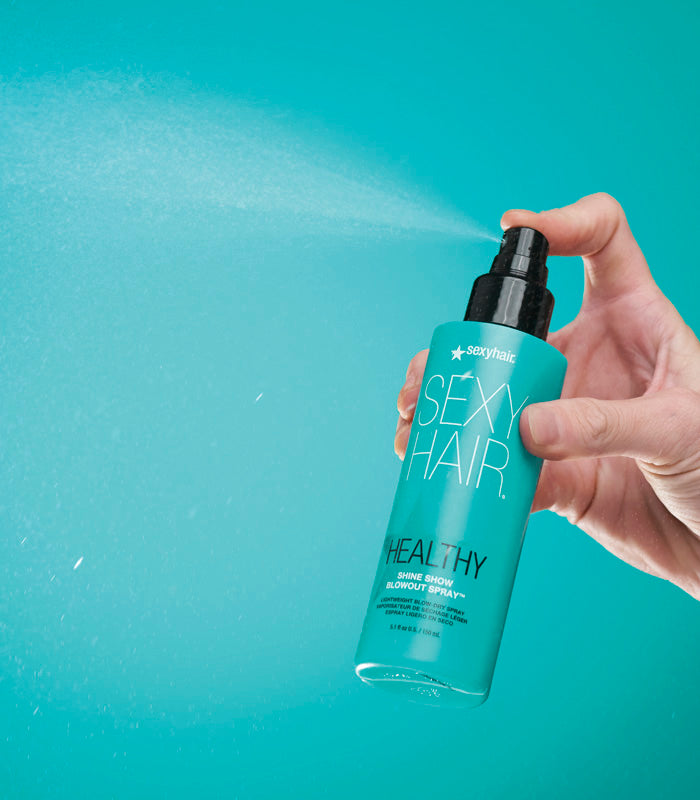 Hand holding Healthy SexyHair Shine Show Blowout Spray bottle