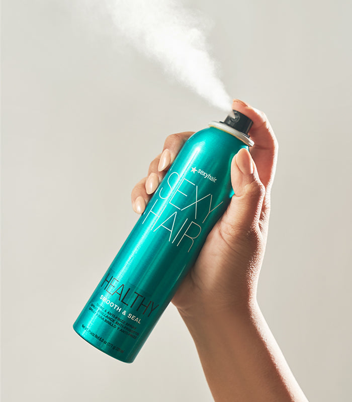 Hand spraying Healthy SexyHair Smooth & Seal hairspray