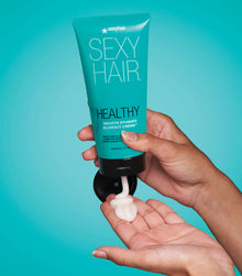Healthy SexyHair Smooth Stunner Blowout Crème dispensing from tube into hand