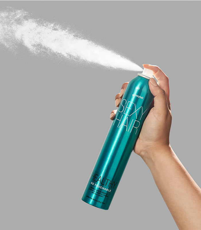 Hand spraying Healthy SexyHair So Touchable hairspray