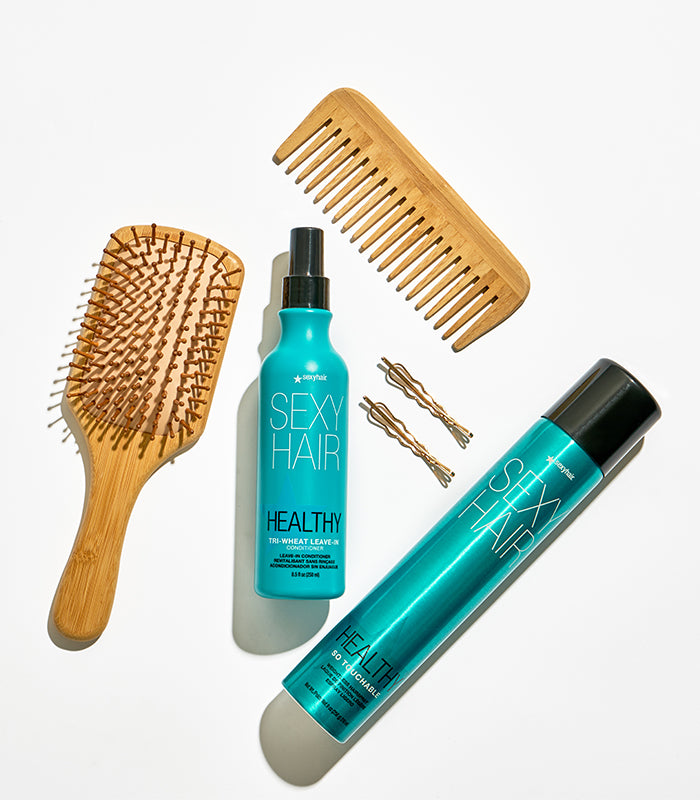 Healthy SexyHair products with hairbrush and accessories on white background
