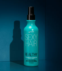 Healthy SexyHair Tri-Wheat Leave-In Conditioner spray bottle on teal background