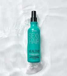 Healthy SexyHair Tri-Wheat Leave-In Conditioner on white background with water