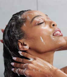 Model shampooing wet hair with I Want SexyHair Moisture in shower