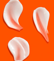 I Want SexyHair Strength creamy conditioner texture swatches on orange background