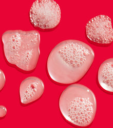 I Want SexyHair Volume shampoo gel texture bubbles on red background