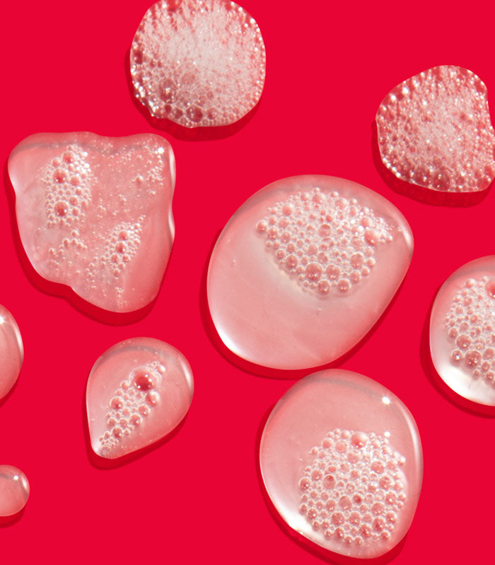 I Want SexyHair Volume shampoo gel texture bubbles on red background