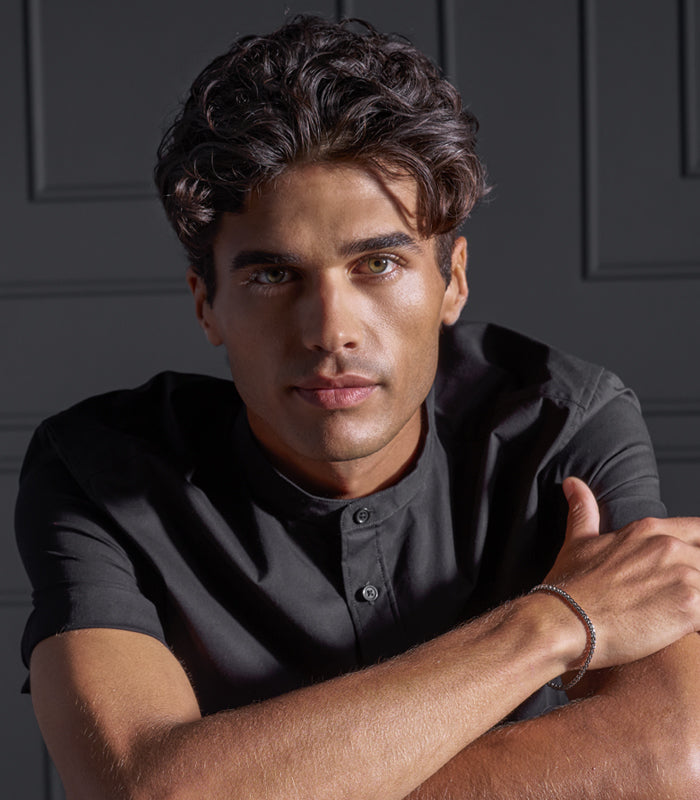 Male model displaying voluminous full hairstyle created with Blow It Up styling foam