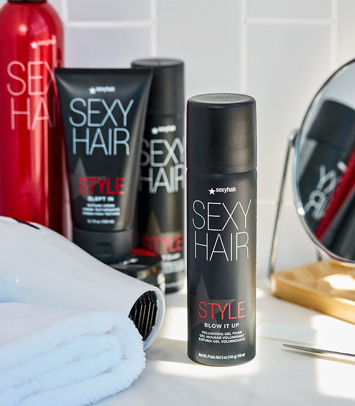 Style SexyHair Blow It Up product arranged with complementary bathroom styling accessories