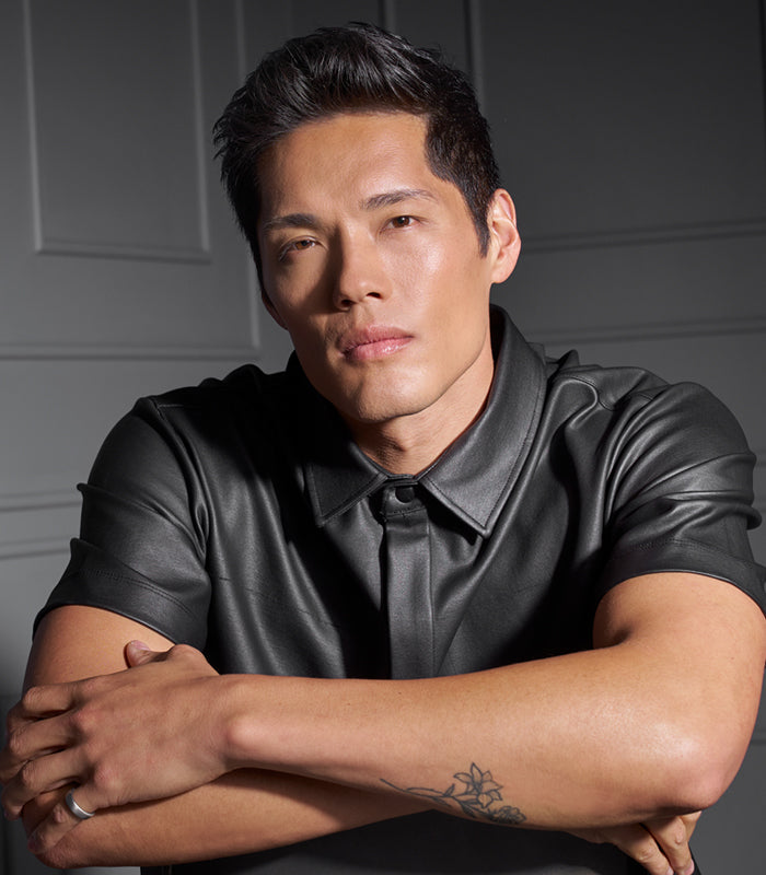 Male model with styled hair created using Style SexyHair Hard Up holding gel product