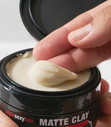 Style SexyHair Matte Clay texture being scooped from black jar container display