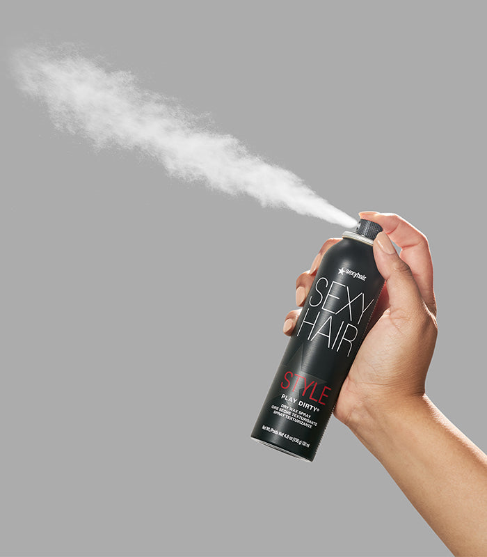 Style SexyHair Play Dirty spray being dispensed creating white texture mist effect