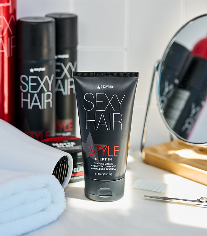 Style SexyHair Slept In texture crème displayed with professional styling tools