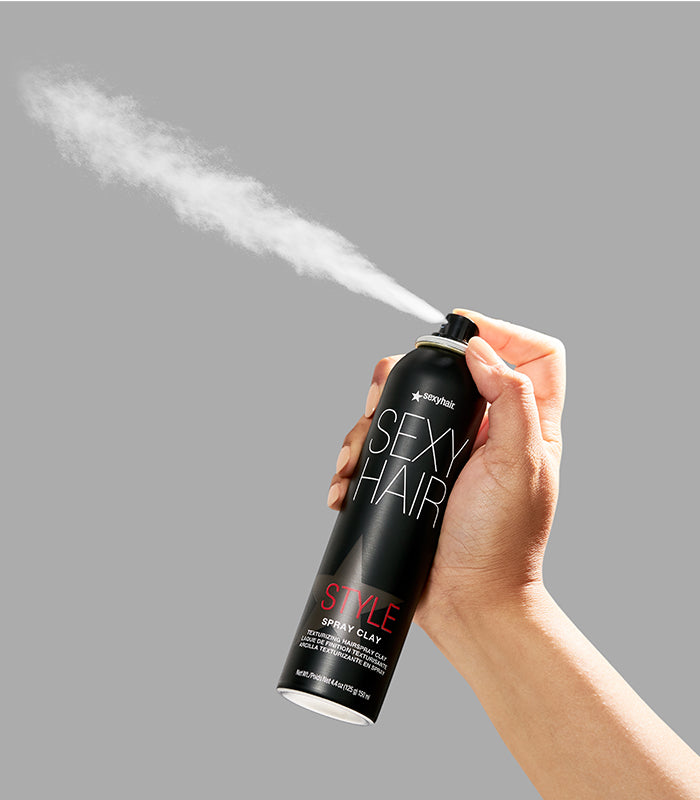 Style SexyHair Spray Clay texturizing spray being dispensed creating white mist
