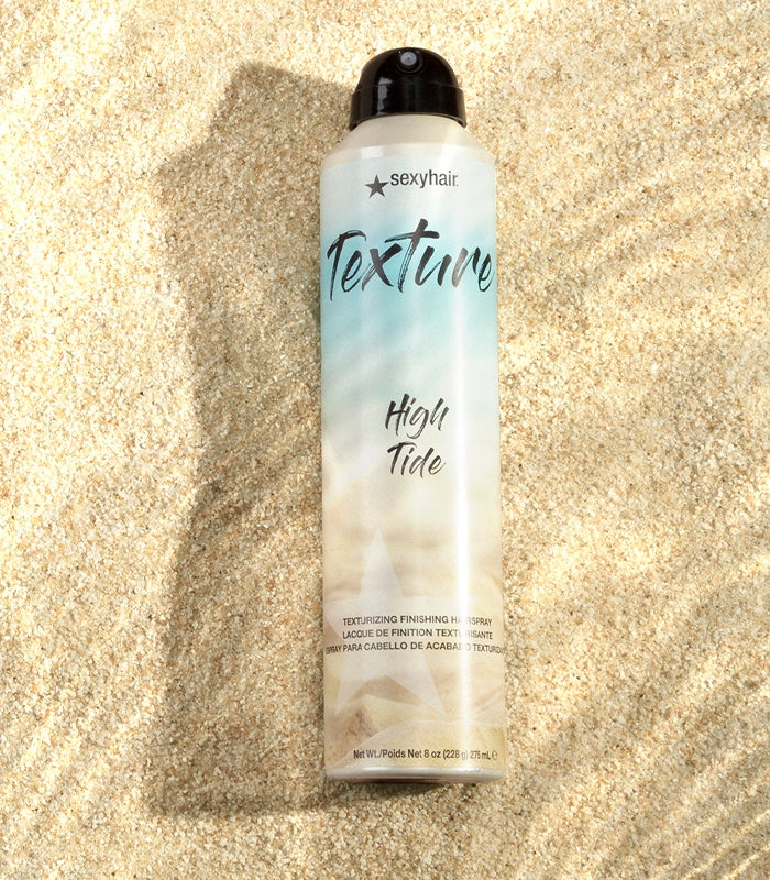 Texture SexyHair High Tide hairspray bottle on sandy textured background