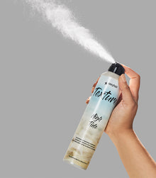 Hand holding Texture SexyHair High Tide hairspray spraying product mist